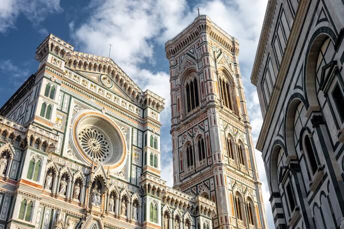 Ornate marble details in Florence standing out on the Duomo complex, with the cathedral façade and soaring Campanile dominating the view.
