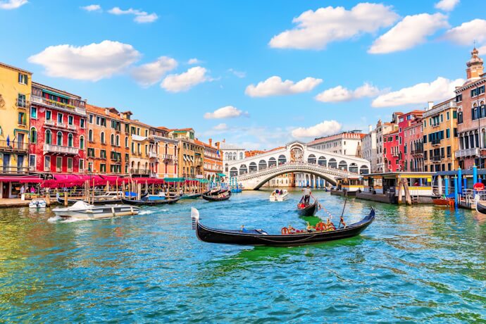 Gondolier crossing Venice’s Grand Canal near Rialto Bridge