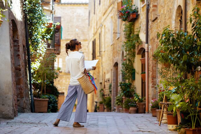 Traveler walking along a traditional Tuscan street