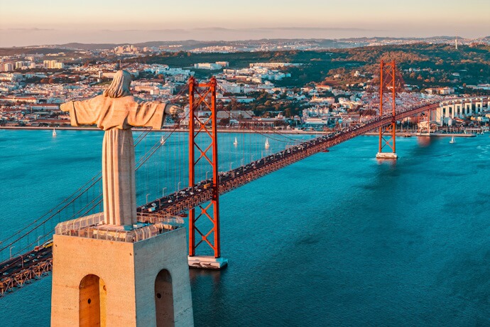Cristo Rei overlooking the 25 de Abril Bridge in Almada, Portugal.