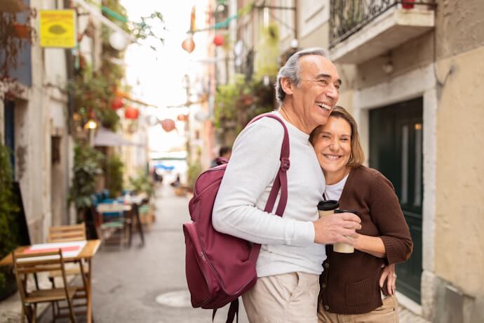 Couple walking through a traditional neighborhood in Lisbon, Portugal.
