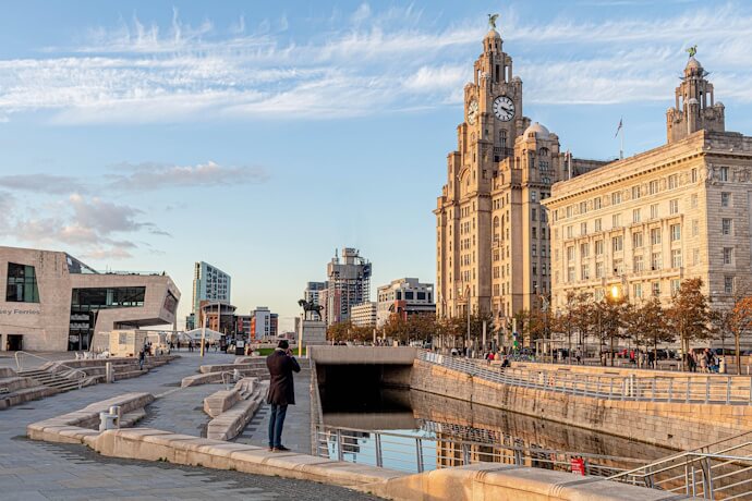 View of the Liverpool waterfront at sunset featuring the iconic Royal Liver Building