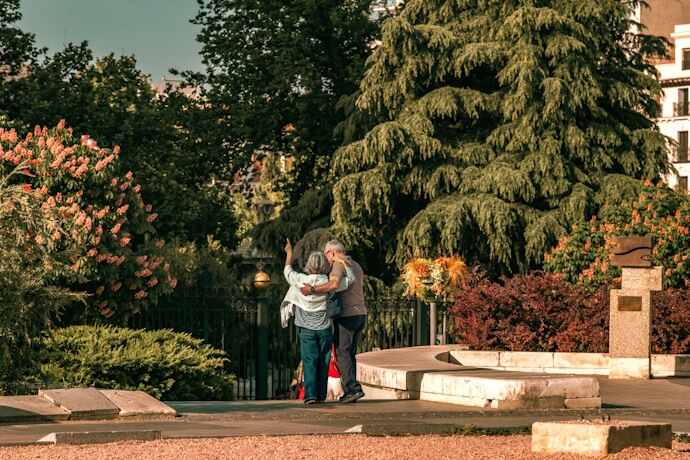 Quiet garden setting in Madrid surrounded by trees, fountains, and historic architecture.
