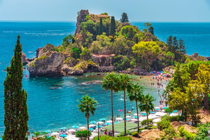 People enjoying the beach at sunny Isola Bella, Sicily