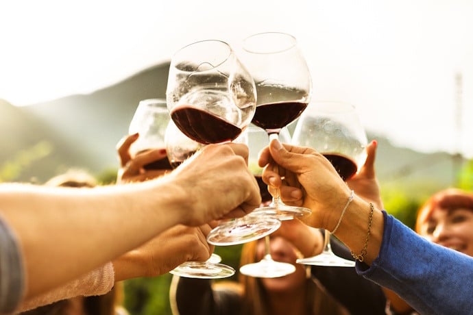 Friends cheering with Madeira wine