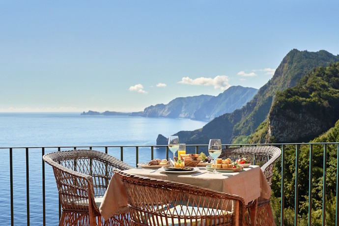 Typical Madeiran meal with a view over a cliff and the Atlantic Ocean