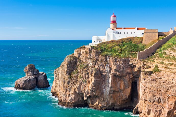Dramatic cliffs and a lighthouse at Cape St. Vincent, Sagres, Algarve.