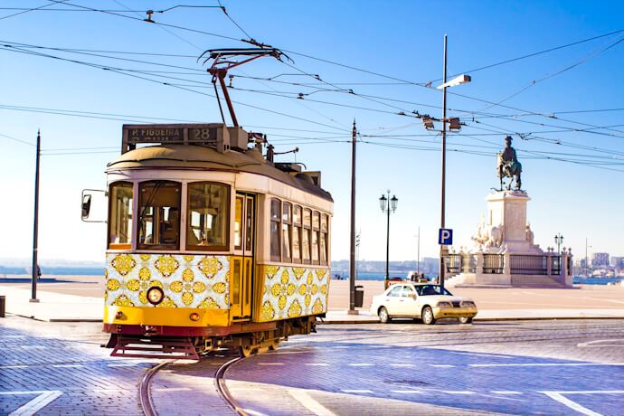 Historic tram beside Praça do Comércio in Lisbon, Portugal.