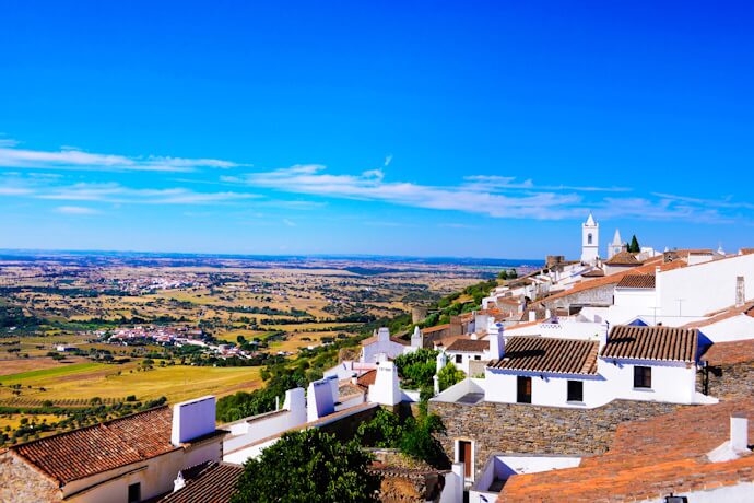 Whitewashed hilltop houses in historic Évora, Portugal.