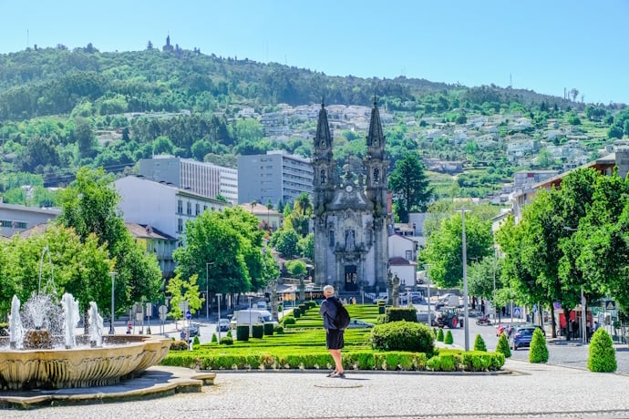 Tourist photographing a square in Guimarães, Portugal