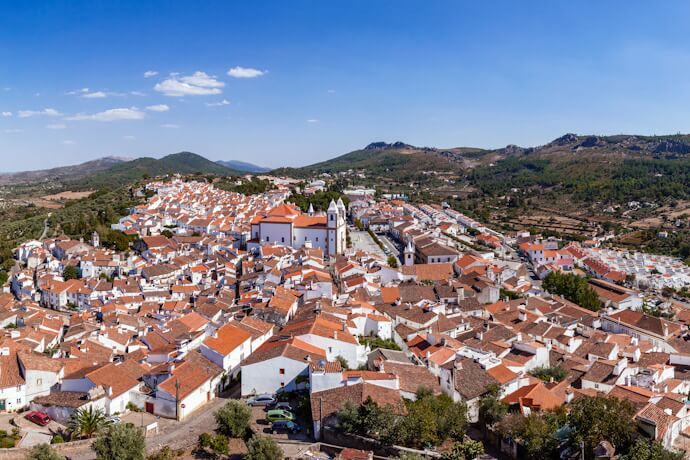Panoramic view of Castelo de Vide in the Alentejo, Portugal, with whitewashed houses and rolling hills in the background