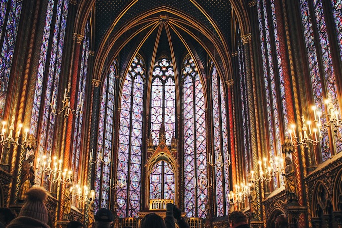 People admiring the Gothic stained-glass windows in Sainte-Chapelle, Paris