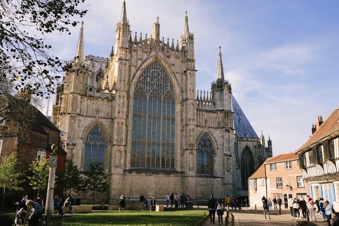 People passing by York Minster, a Gothic marvel in York, England