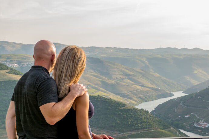 Couple admiring the scenic views of Douro Valley and Douro River, in Portugal