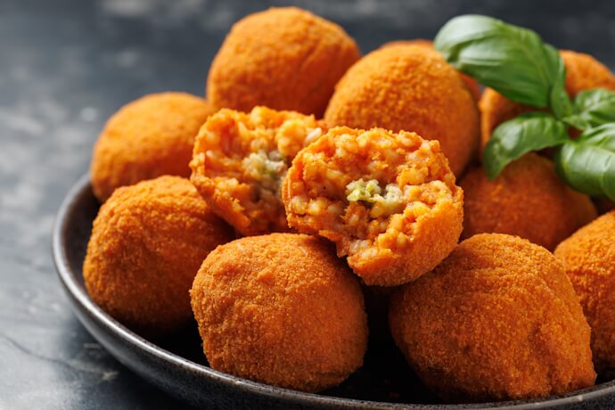 Arancini on a plate with basil