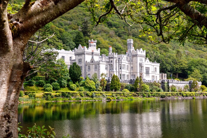 Kylemore Abbey beside a peaceful lake in Connemara, Ireland.