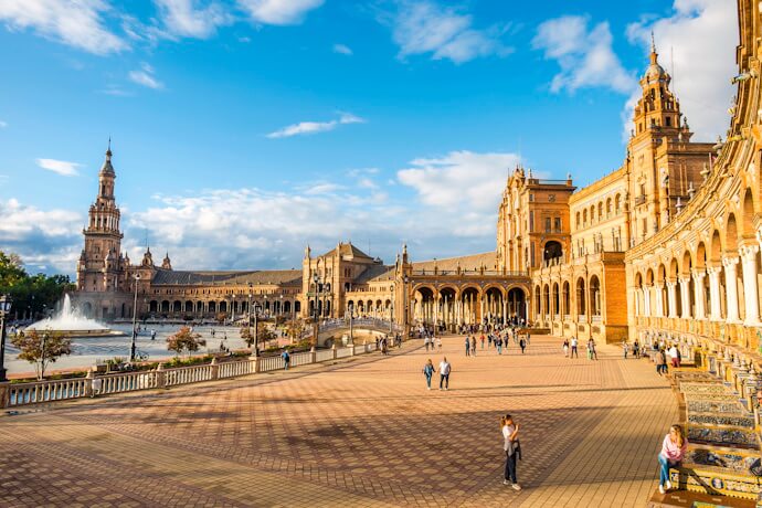 The grandeur of Plaza de España shines under the Andalusian sky in Seville.