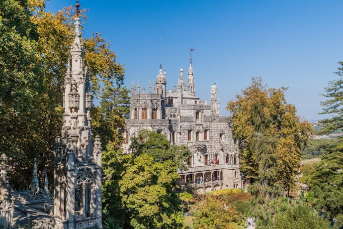 People exploring the green landscape of Quinta da Regaleira in Sintra