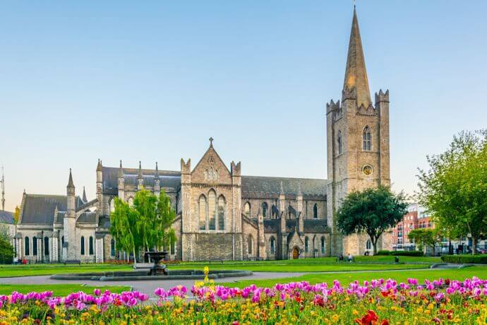 St Patrick’s Cathedral in Dublin, Ireland, surrounded by gardens and flowers on a sunny day