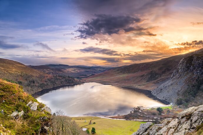 Lough Tay in Wicklow Mountains with dramatic valley views at sunset in Ireland