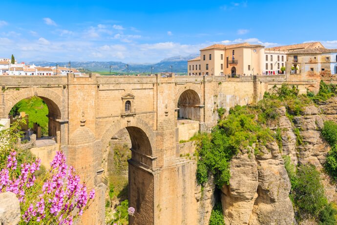 Morning light illuminating Ronda’s Puente Nuevo bridge spanning the dramatic El Tajo gorge in Andalusia.