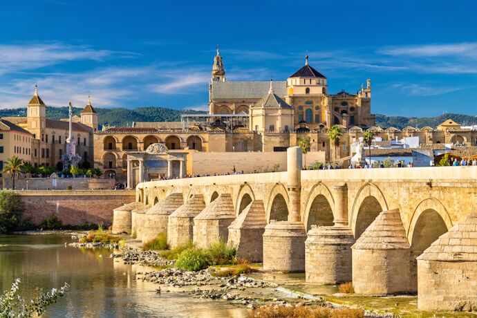 Roman Bridge of Córdoba with the Mezquita-Cathedral rising behind it along the Guadalquivir River.