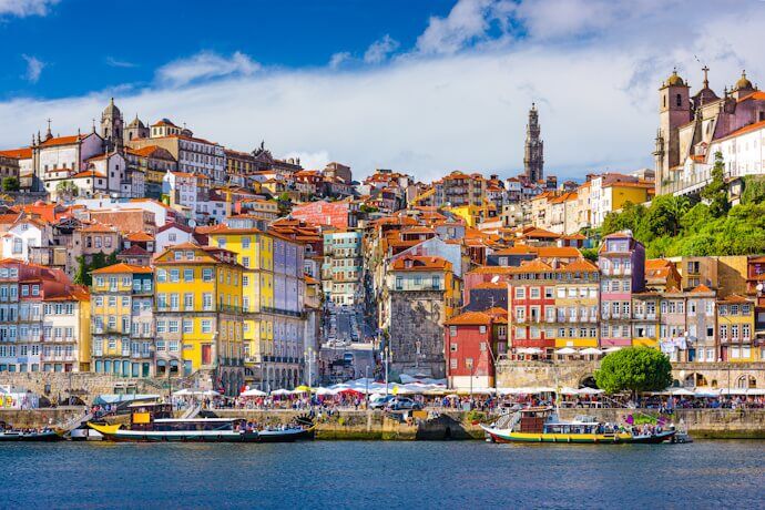 Vibrant Ribeira district in Porto with view of the Douro River and boats