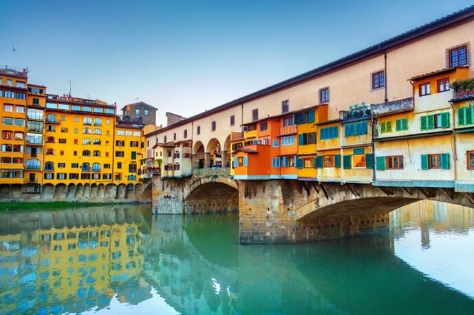 Cross Ponte Vecchio and admire the former shops
