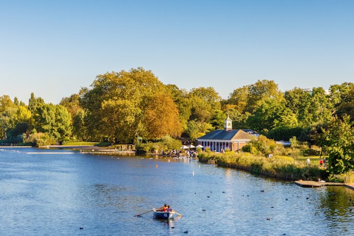 Serpentine lake in Hyde Park with people on a boat