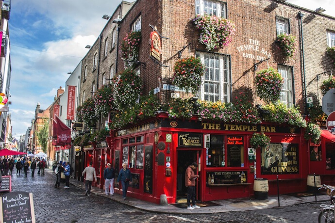 Temple Bar Pub in Dublin, Ireland, in the Temple Bar District and cobblestone streets filled with visitors