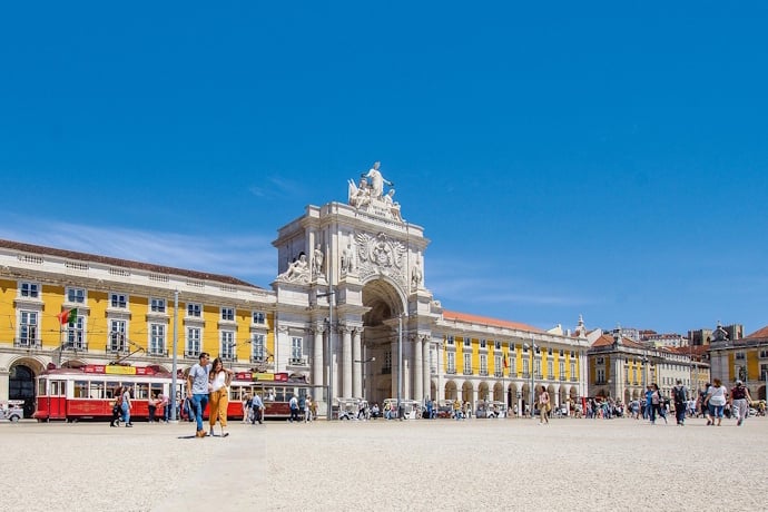 People enjoying a sunny day in Lisbon's Commerce Square