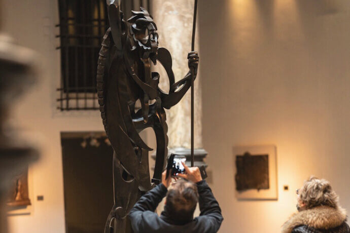 Person taking a photo of a sculpture at the Pablo Gargallo Museum in Zaragoza