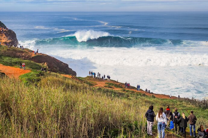 Famous for its towering Atlantic waves, Nazaré draws surf enthusiasts and spectators to its dramatic coastline.