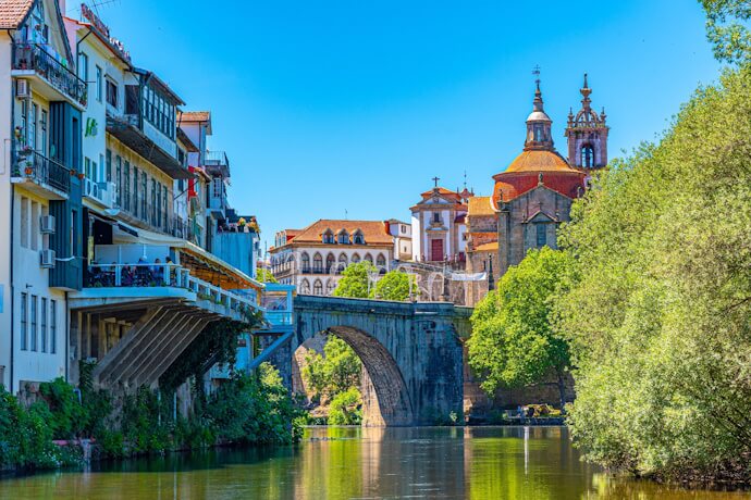 Amarante town, with charming houses, a historic stone bridge, and the grand Church of São Gonçalo overlooking the Tâmega River.