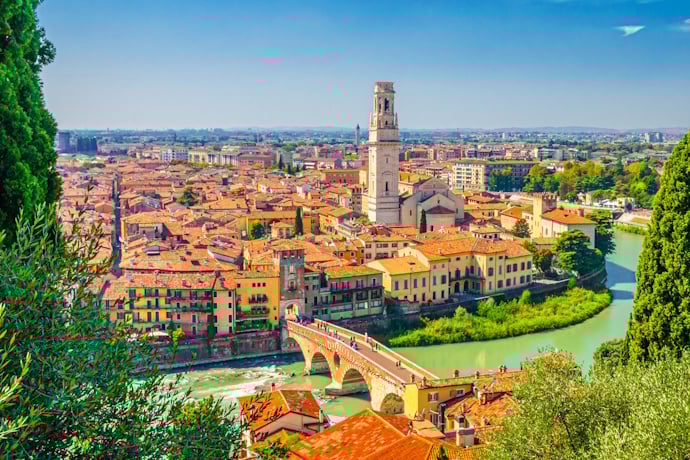 Verona’s historic center with Ponte Pietra and the Adige River, framed by terracotta rooftops 