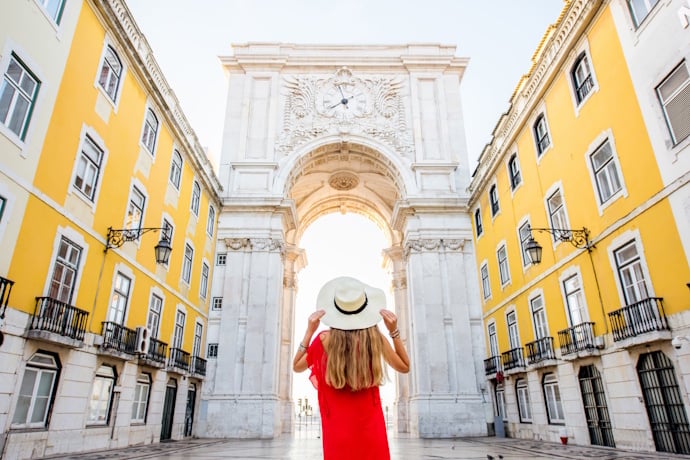 Person overlooking the Rua Augusta Arch in Baixa, Lisbon