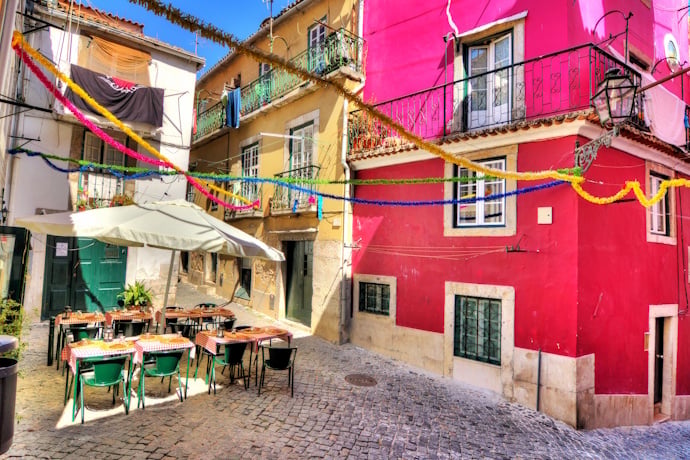 Colorful street with festive garlands in Mouraria, Lisbon