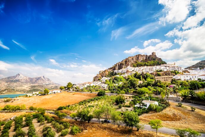 Panoramic view of Zahara de la Sierra, a whitewashed village perched on a rocky hilltop in Andalusia, Spain