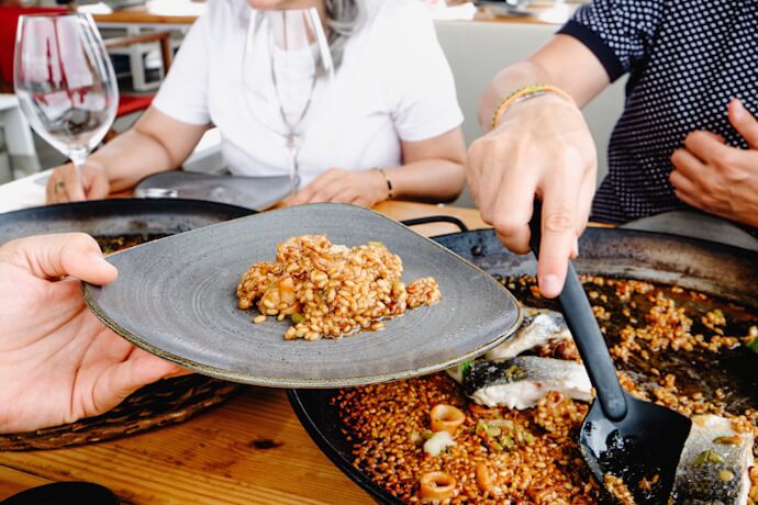 Traditional Spanish seafood paella being served at a restaurant