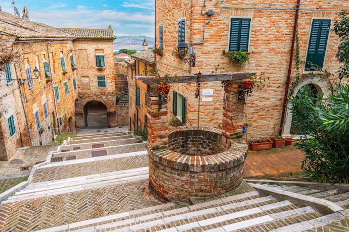 Stepped historic streets and brick houses in Corinaldo, Ancona Province.