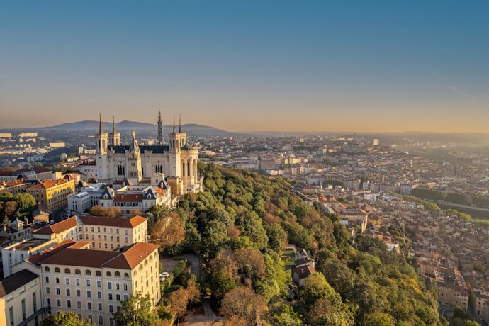 Aerial view of Lyon’s Fourvière Basilica overlooking the city and surrounding hills.