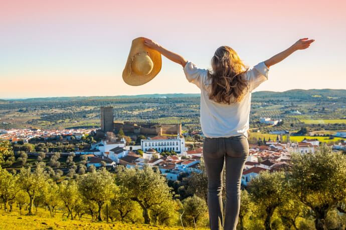 Traveler overlooking Évora and the Alentejo countryside