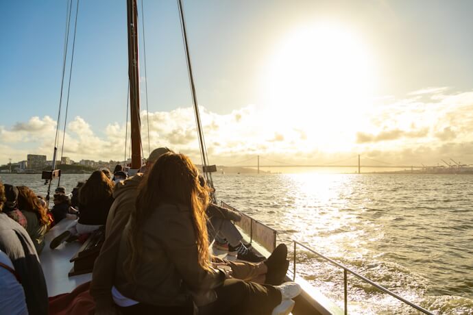 Sailboat cruise on the Tagus River at sunset