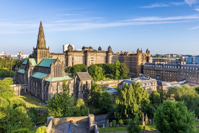 Glasgow Cathedral in Scotland surrounded by green parkland, showcasing Gothic architecture