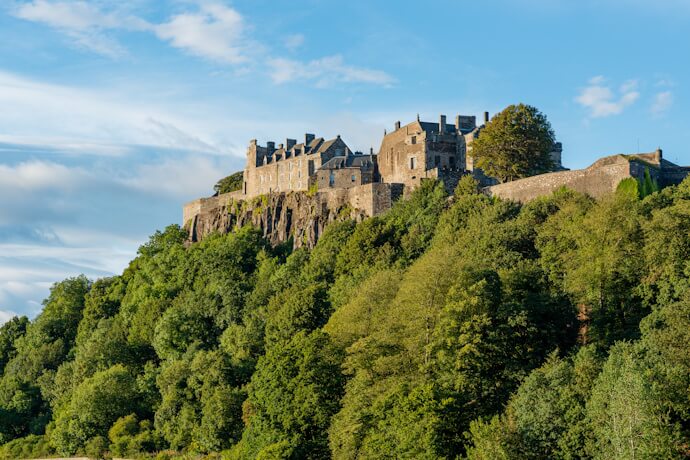 Stirling Castle perched on a rocky hilltop in Scotland, overlooking lush green countryside