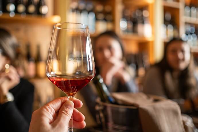 Hand holding a glass of Madeira wine during a tasting in Funchal, Portugal