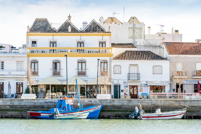 Traditional fishing boats along the waterfront in Tavira, Portugal.