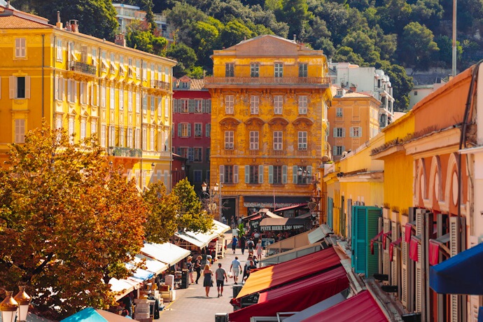 Bright yellow ochre buildings of Nice’s Old Town flank the bustling Cours Saleya market