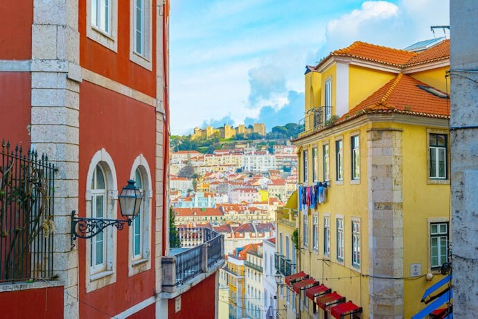 Colorful historic buildings in Lisbon with São Jorge Castle overlooking the city